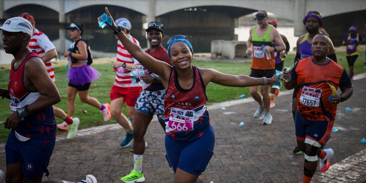 Diverse group of runners celebrating after a race